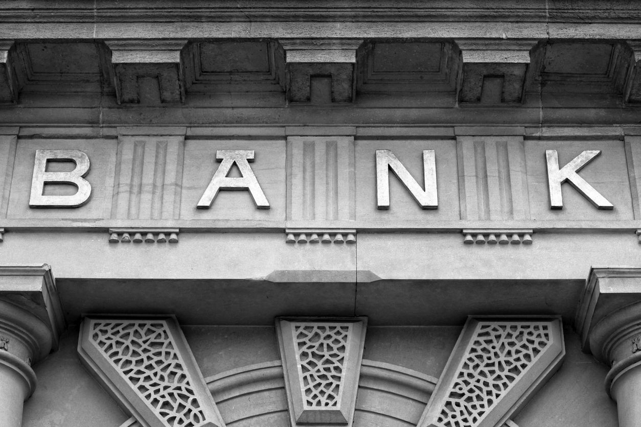 Embossed letters spell bank above the door of financial building